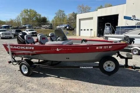 The Image of 2014 Tracker Pro Guide V-16 SC boat on trailer, parked outdoors. - 0