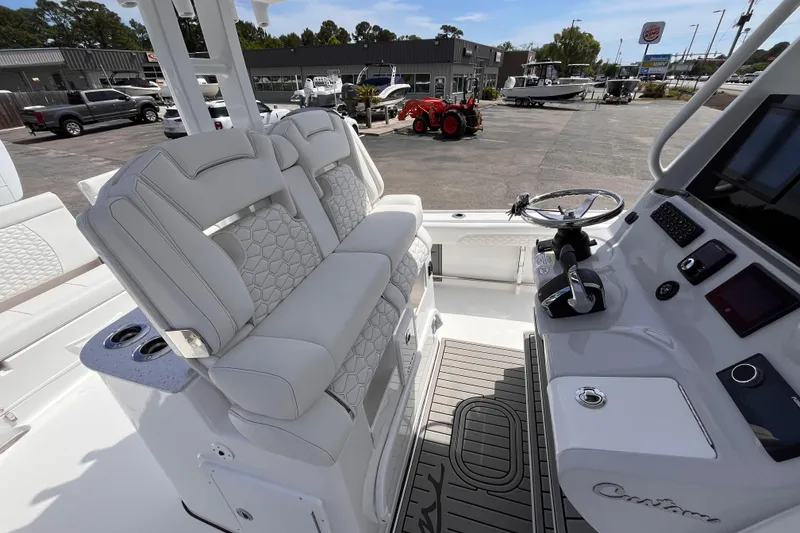 Slide: The Image of 2026 Tidewater 3100 Carolina Bay boat interior with dual seats and modern helm controls. - 10