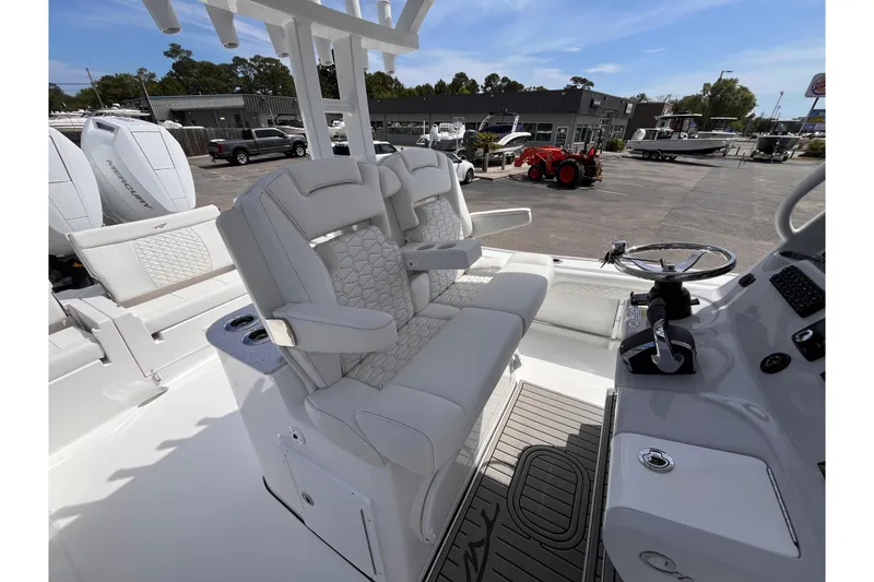 Slide: The Image of 2026 Tidewater 3100 Carolina Bay boat interior with luxurious seating and modern helm controls. - 11
