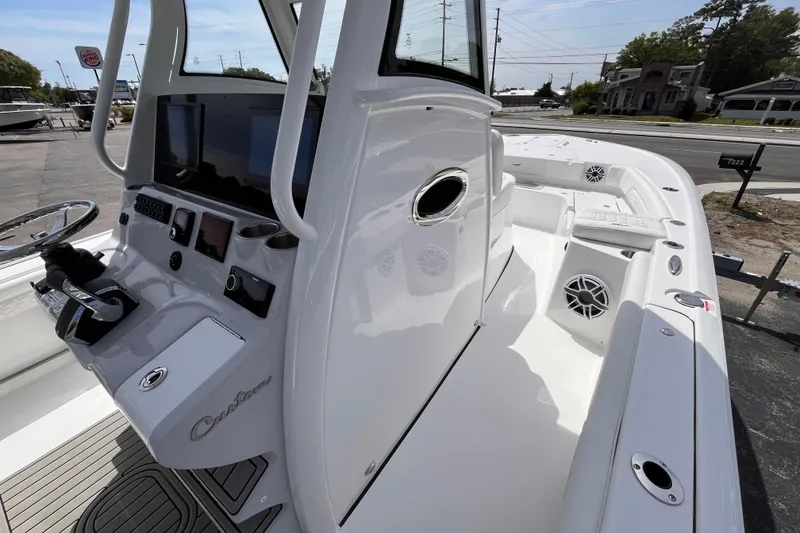 Slide: The Image of 2026 Tidewater 3100 Carolina Bay boat interior with modern dashboard and seating. - 13