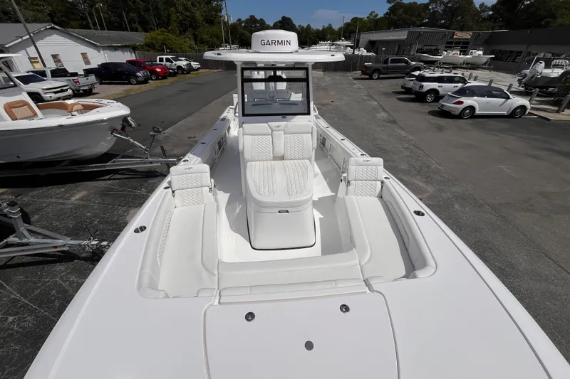 Slide: The Image of 2026 Tidewater 3100 Carolina Bay boat with white seating, parked in a dealership lot. - 16