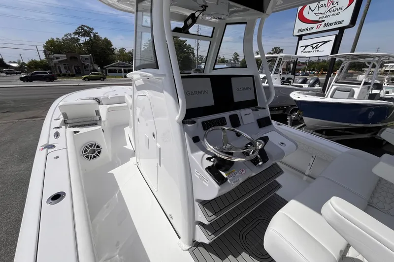 Slide: The Image of 2026 Tidewater 3100 Carolina Bay boat with Garmin displays at Marker 17 Marine dealership. - 19