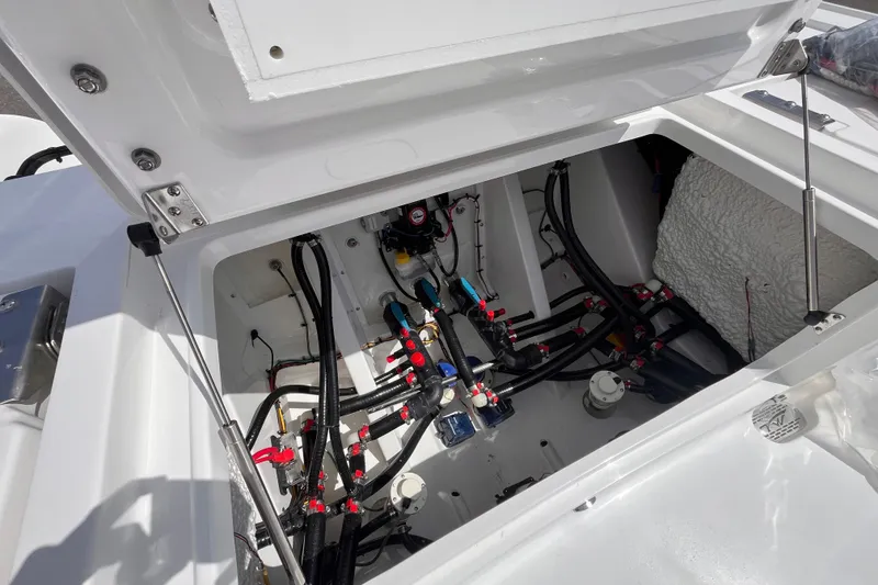Slide: The Image of Open hatch of 2026 Tidewater 3100 Carolina Bay boat showing internal wiring and components. - 21