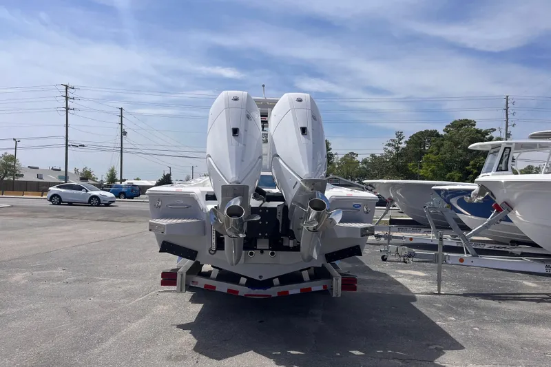 Slide: The Image of 2026 Tidewater 3100 Carolina Bay boat with dual outboard motors in a marina setting. - 5