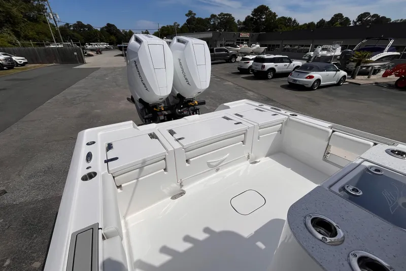 Slide: The Image of 2026 Tidewater 3100 Carolina Bay boat with dual Mercury engines in a dealership lot. - 7