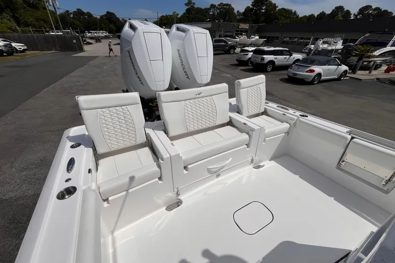 Slide: The Image of 2026 Tidewater 3100 Carolina Bay boat with white seating and dual Mercury engines. - 8