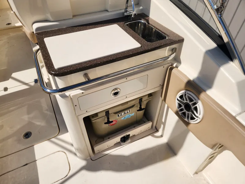 Slide: The Image of Scout 255 Dorado 2022 boat kitchenette with sink and Yeti cooler. - 24