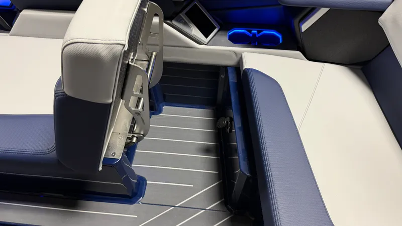 Slide: The Image of Interior of a 2027 MasterCraft X23 with blue and white seating and blue lighting. - 44