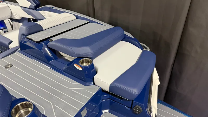 Slide: The Image of The image shows the rear of a MasterCraft X23 boat with blue and white upholstery. - 15