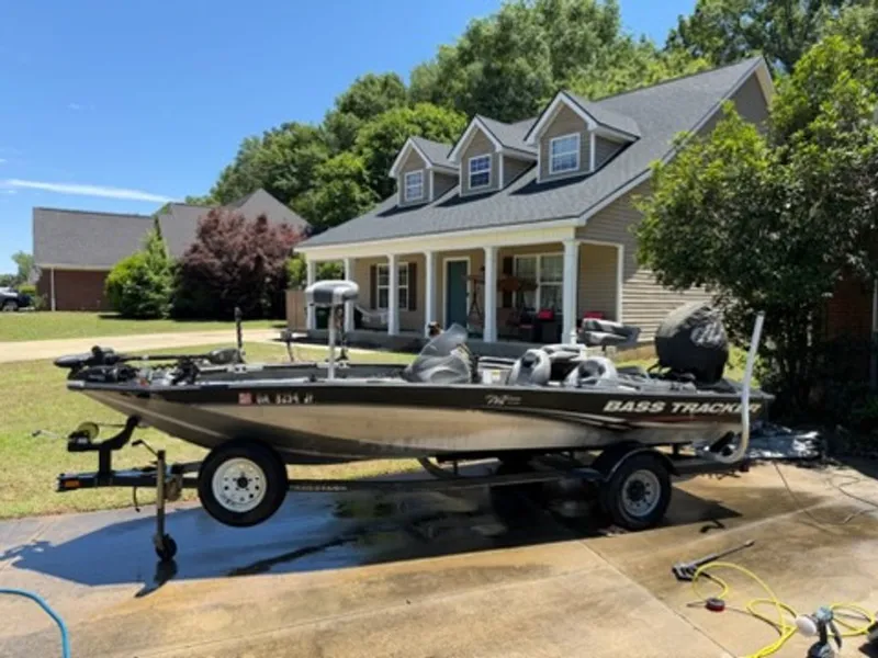 The Image of 2008 Bass Tracker Pro Team boat on driveway in front of house. - 0