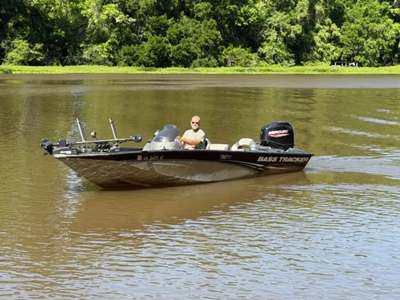 Slide: The Image of 2008 Bass Tracker Pro Team boat on calm river. - 10