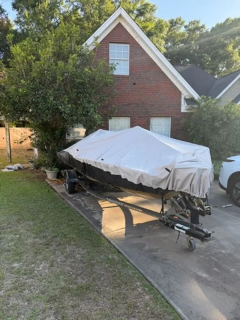 Slide: The Image of 2008 Bass Tracker Pro Team boat covered in driveway. - 14