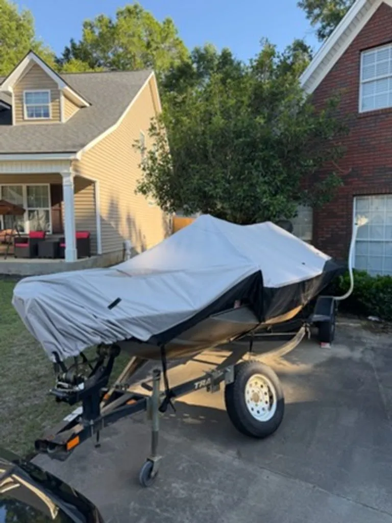 Slide: The Image of 2008 Bass Tracker Pro Team boat covered in driveway. - 16