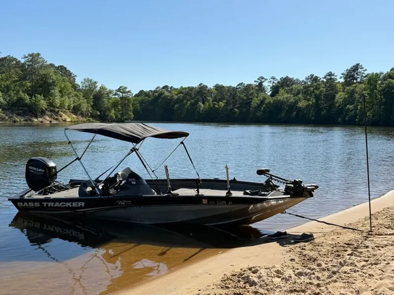 Slide: The Image of 2008 Bass Tracker Pro Team boat on sandy riverbank. - 3