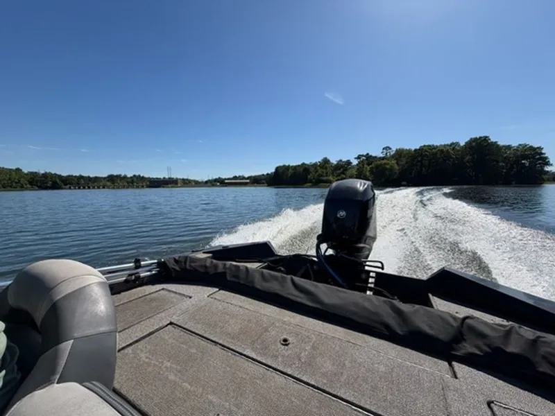 Slide: The Image of 2008 Bass Tracker Pro Team boat on a calm lake. - 6