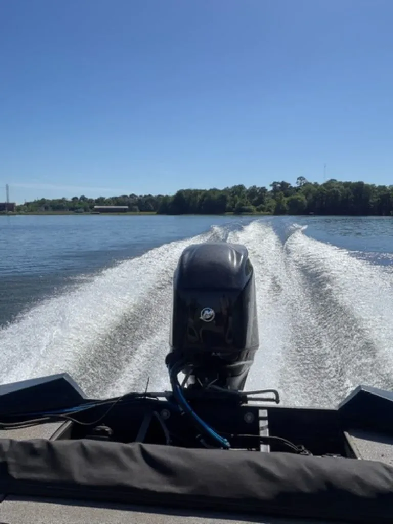 Slide: The Image of Bass Tracker Pro Team 2008 on a lake, motor in action. - 7