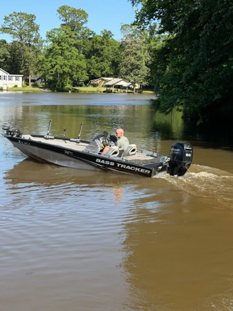 Slide: The Image of 2008 Bass Tracker Pro Team boat on a calm lake. - 8