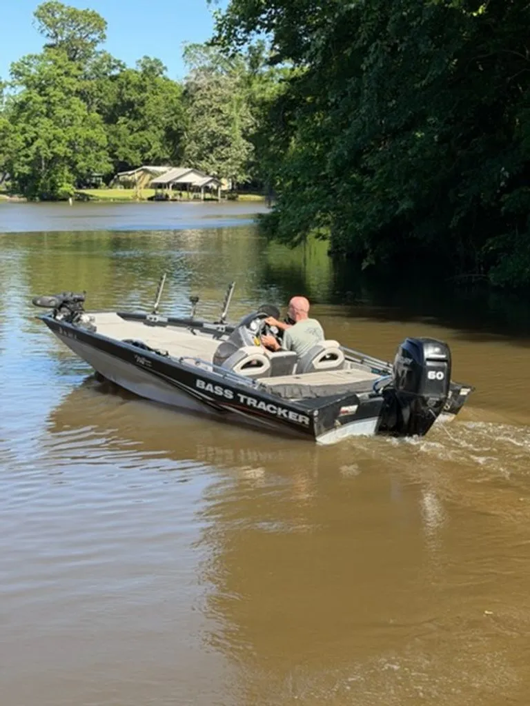 Slide: The Image of 2008 Bass Tracker Pro Team boat on a calm river. - 9