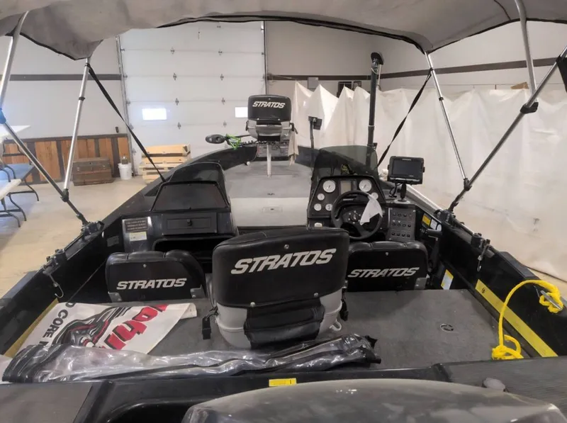 Slide: The Image of Interior view of a 1997 Stratos 219 F boat in a garage. - 4