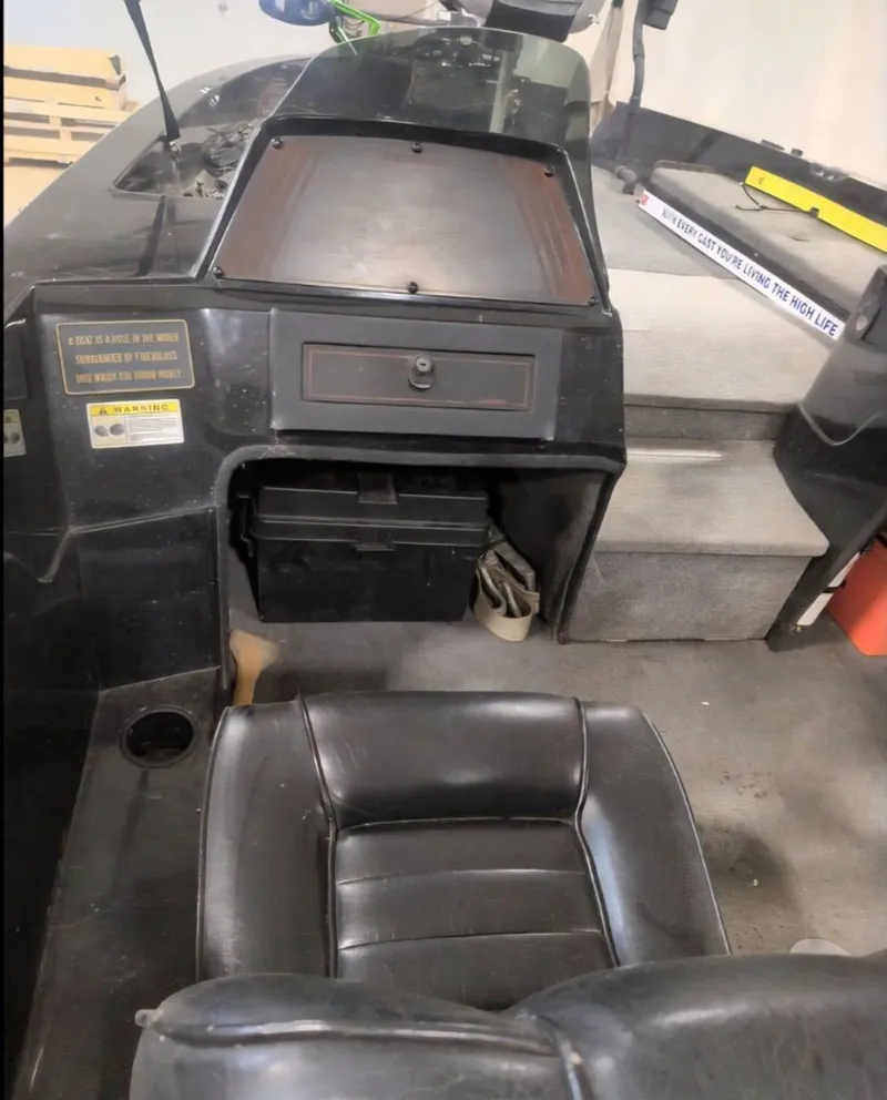 Slide: The Image of Interior of a 1997 Stratos 219 F boat with black seat. - 6