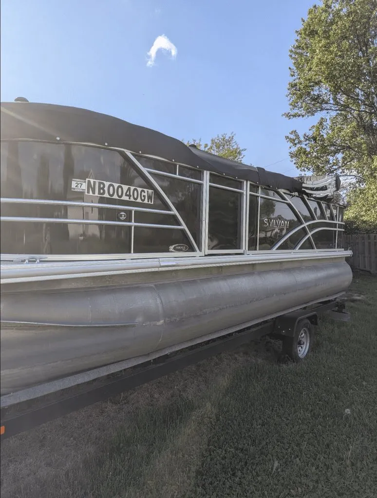 The Image of Sylvan Mirage 820 pontoon boat, 2022, parked on trailer outdoors. - 0