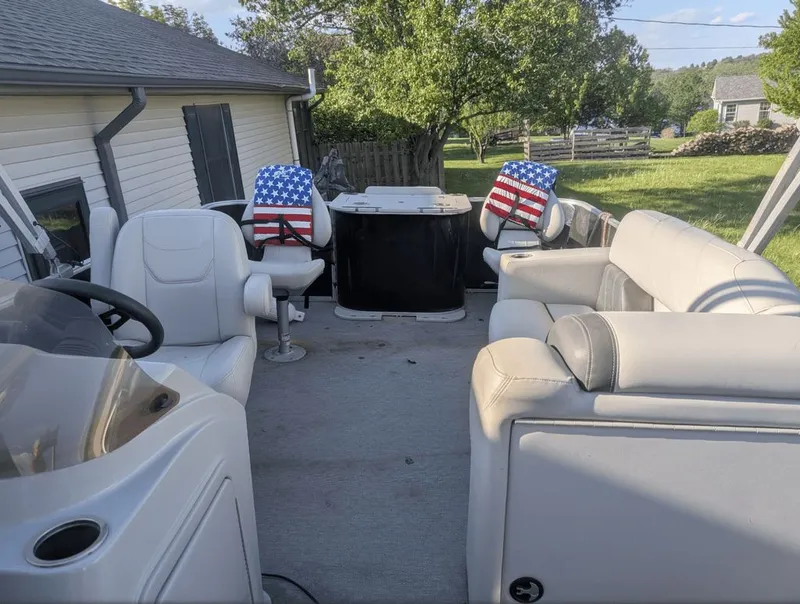 Slide: The Image of Interior of a 2022 Sylvan Mirage 820 pontoon boat with American flag chairs. - 2