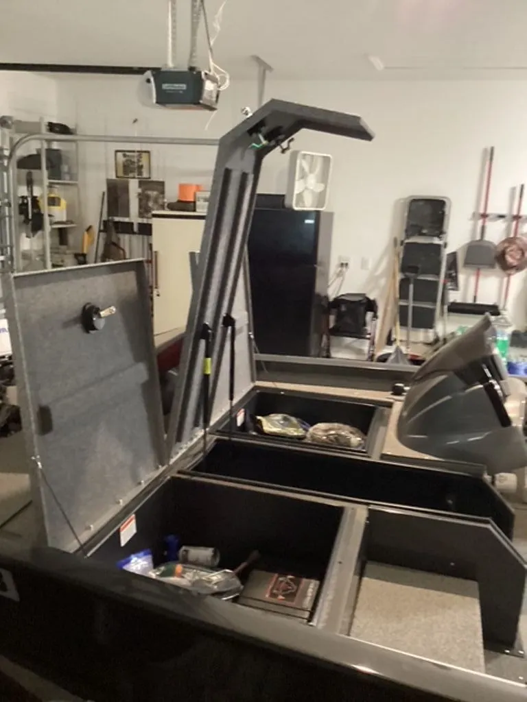 Slide: The Image of 2022 G3 Sportsman boat with open storage compartments in garage. - 11
