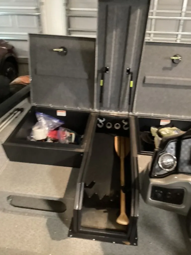 Slide: The Image of G3 Sportsman 2022 boat with storage compartments and paddle. - 12