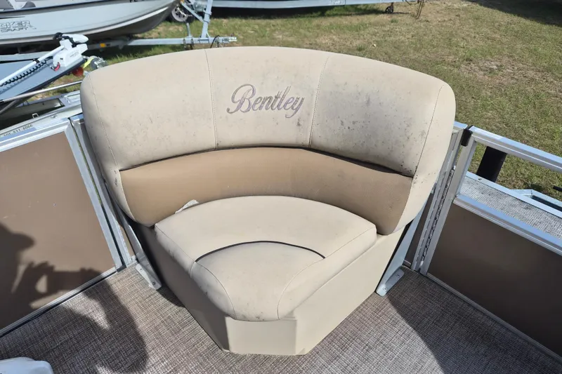 Slide: The Image of Bentley Pontoons 180 CRUISE 2004 boat seat with beige upholstery and logo. - 12