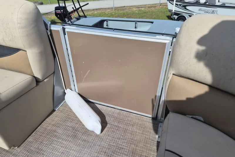 Slide: The Image of Interior of a 2004 Bentley Pontoons 180 CRUISE with beige seating and a boat fender. - 16