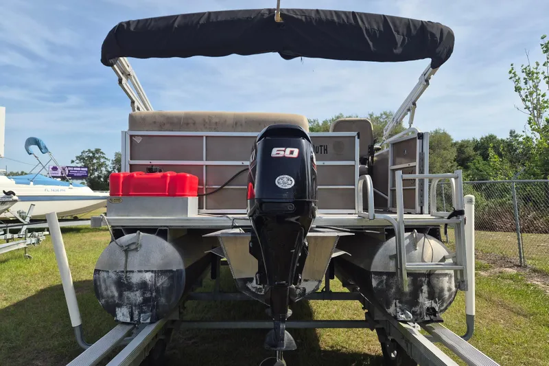 Slide: The Image of 2004 Bentley Pontoons 180 CRUISE with 60 HP outboard motor, parked on grass. - 5