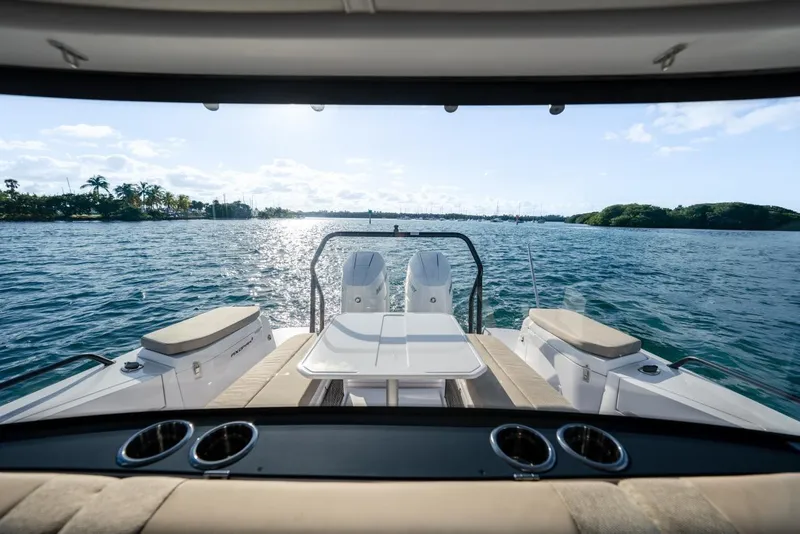 Slide: The Image of 2026 Axopar 37 XC Cross Cabin boat with scenic ocean view and sunny sky. - 10