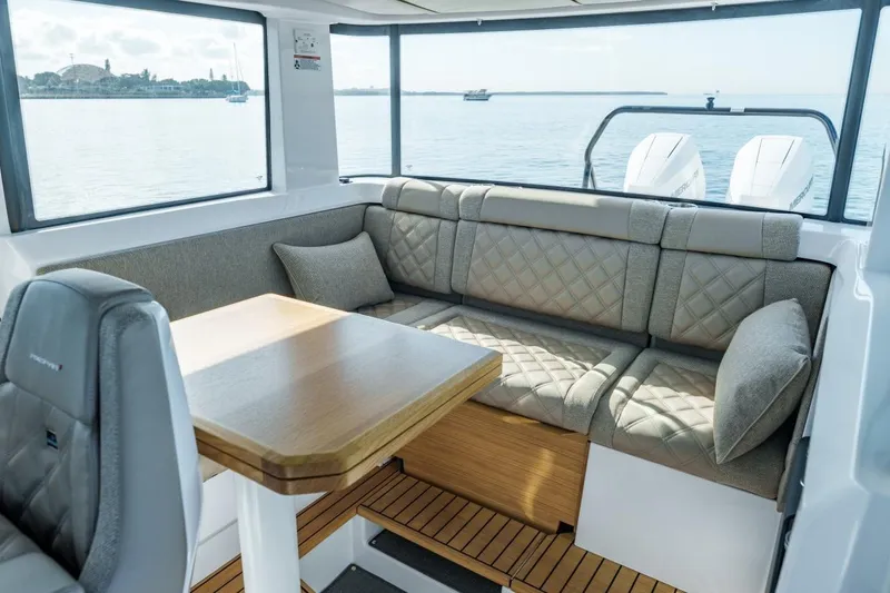 Slide: The Image of Luxurious interior of 2026 Axopar 37 XC Cross Cabin with plush seating and scenic water view. - 8