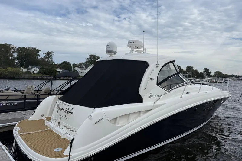 The Image of 2007 Sea Ray 40 Sundancer yacht docked by the water, featuring sleek design and modern amenities. - 0