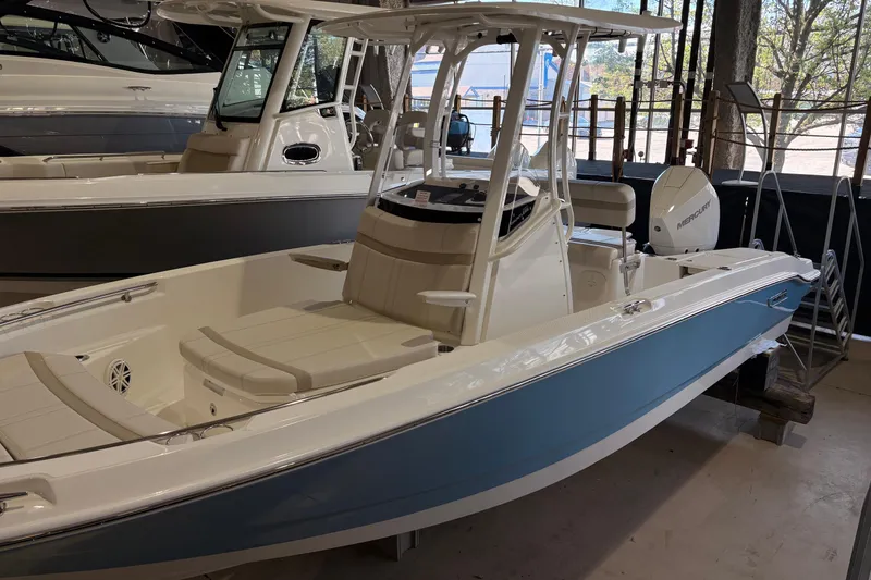 The Image of 2026 Boston Whaler 220 Dauntless boat in showroom, featuring sleek design and modern amenities. - 1