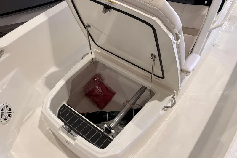 Slide: The Image of Open storage compartment on 2026 Boston Whaler 220 Dauntless boat, showcasing interior space. - 11