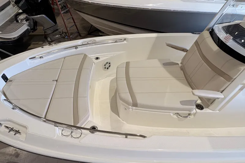 Slide: The Image of 2026 Boston Whaler 220 Dauntless boat interior with cushioned seating and sleek design. - 3