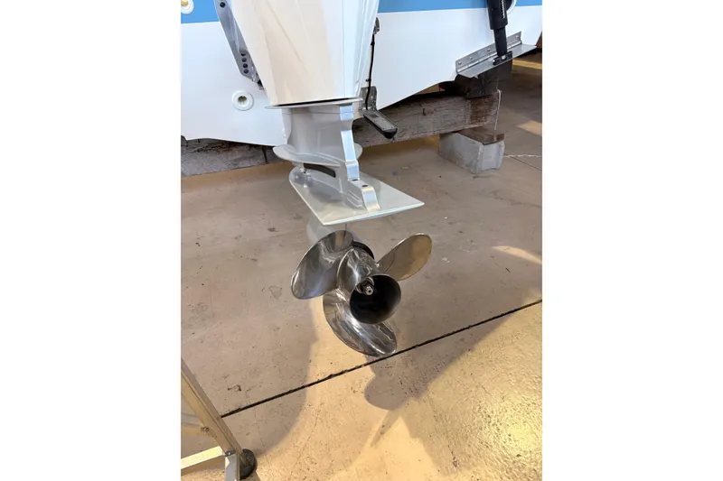 Slide: The Image of Propeller of a 2026 Boston Whaler 220 Dauntless boat on display in a showroom. - 5