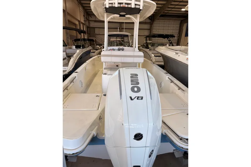 Slide: The Image of 2026 Boston Whaler 220 Dauntless boat with Mercury 250 V8 engine in showroom. - 6