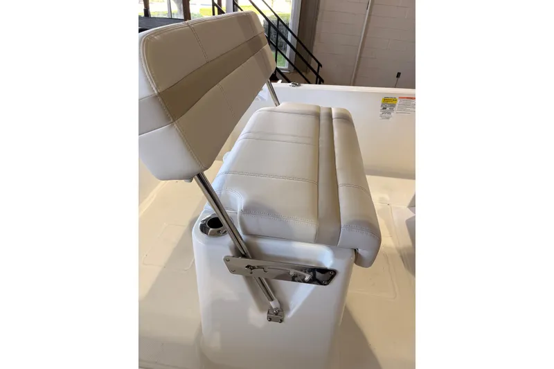 Slide: The Image of 2026 Boston Whaler 220 Dauntless boat seat with white cushioned upholstery and stainless steel frame. - 7