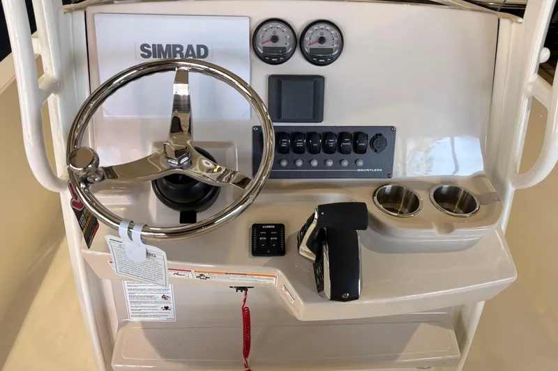 Slide: The Image of 2026 Boston Whaler 220 Dauntless boat console with Simrad display and controls. - 8