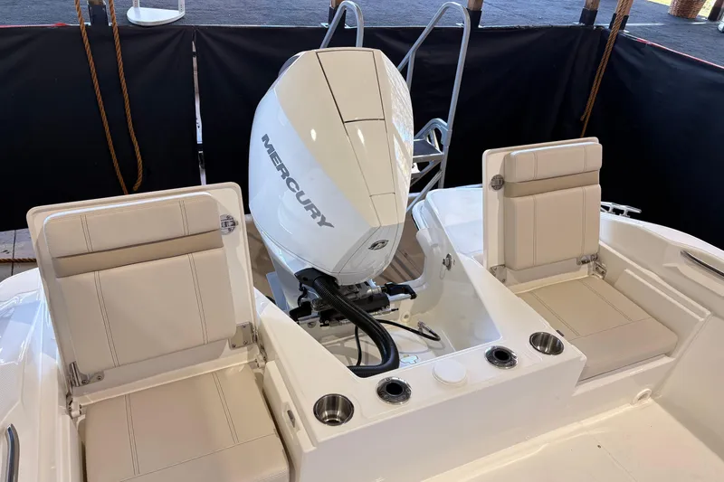 Slide: The Image of 2026 Boston Whaler 220 Dauntless boat with Mercury engine and cushioned seating. - 9