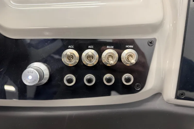 Slide: The Image of Control panel of 2025 Barletta Cabrio 22UC with switches for accessories, bilge, horn, and RGB lighting. - 15