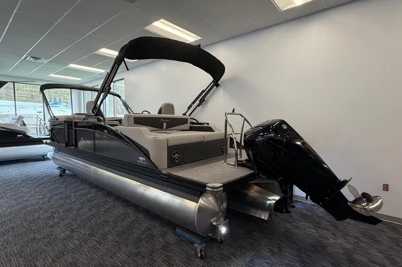 Slide: The Image of 2025 Barletta Cabrio 22UC pontoon boat displayed indoors with sleek design and powerful engine. - 2