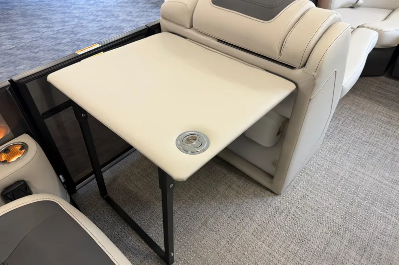 Slide: The Image of 2025 Barletta Cabrio 22UC boat interior with foldable table and cup holder. - 21