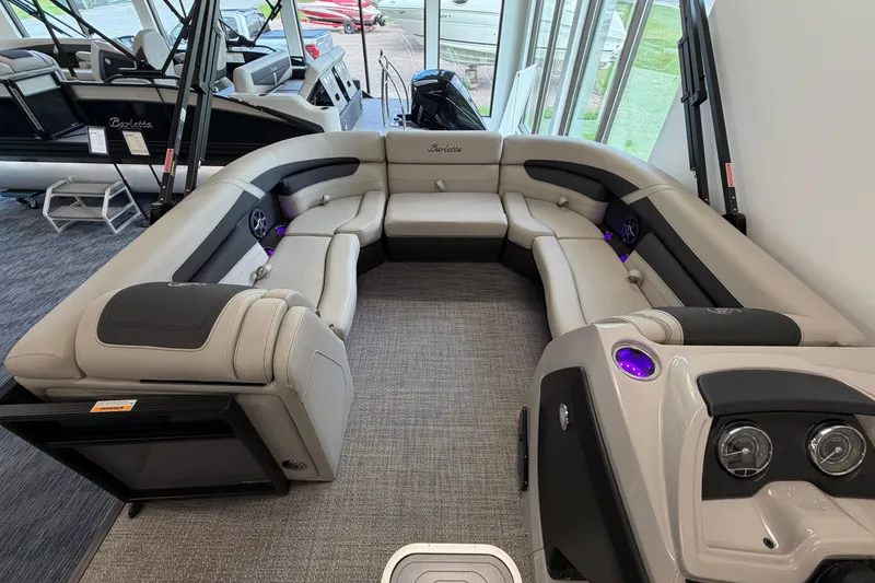 Slide: The Image of 2025 Barletta Cabrio 22UC pontoon boat interior with luxurious seating and modern design. - 22