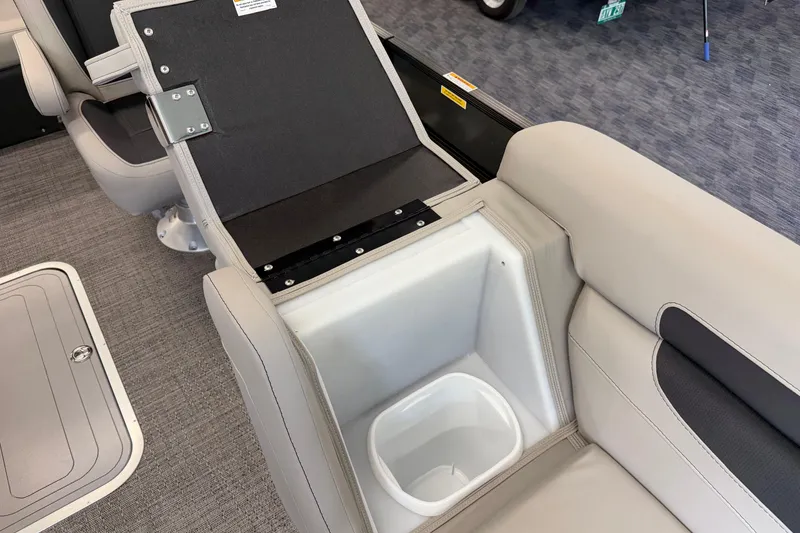 Slide: The Image of 2025 Barletta Cabrio 22UC boat interior with open storage compartment and seating. - 26