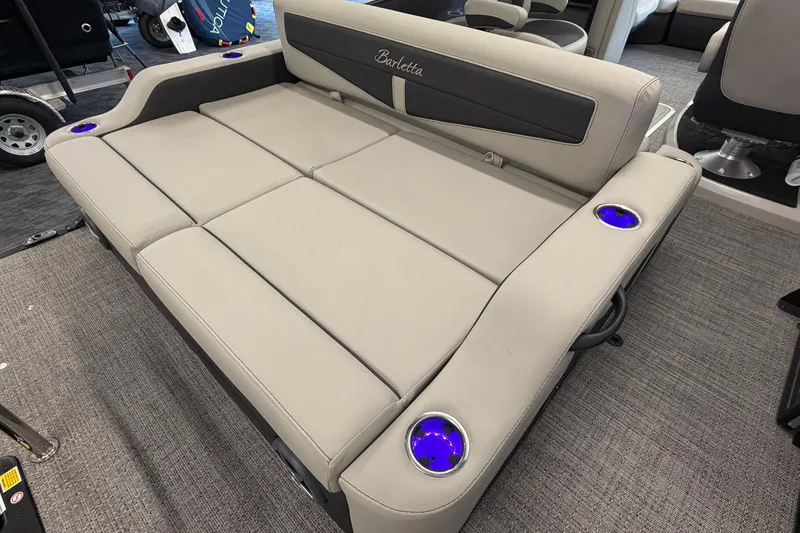Slide: The Image of 2025 Barletta Cabrio 22UC boat interior with beige seating and illuminated cup holders. - 6