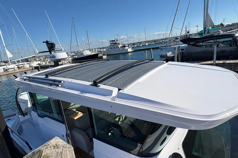 Slide: The Image of 2026 Axopar 37 XC Cross Cabin docked at a marina under clear blue skies. - 8