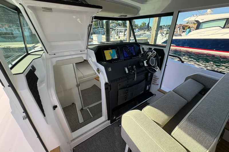 Slide: The Image of Interior of 2026 Axopar 37 XC Cross Cabin with modern helm and seating. - 42